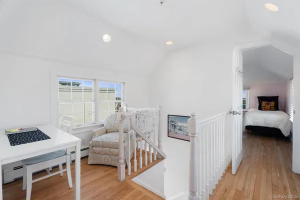 a bedroom with furniture and a wooden floor