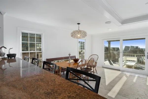 a dining room with furniture and chandelier