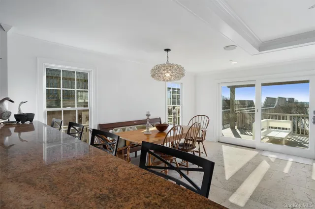 a dining room with furniture and chandelier