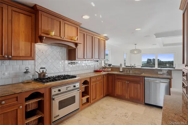 a kitchen with stainless steel appliances granite countertop a sink stove and cabinets