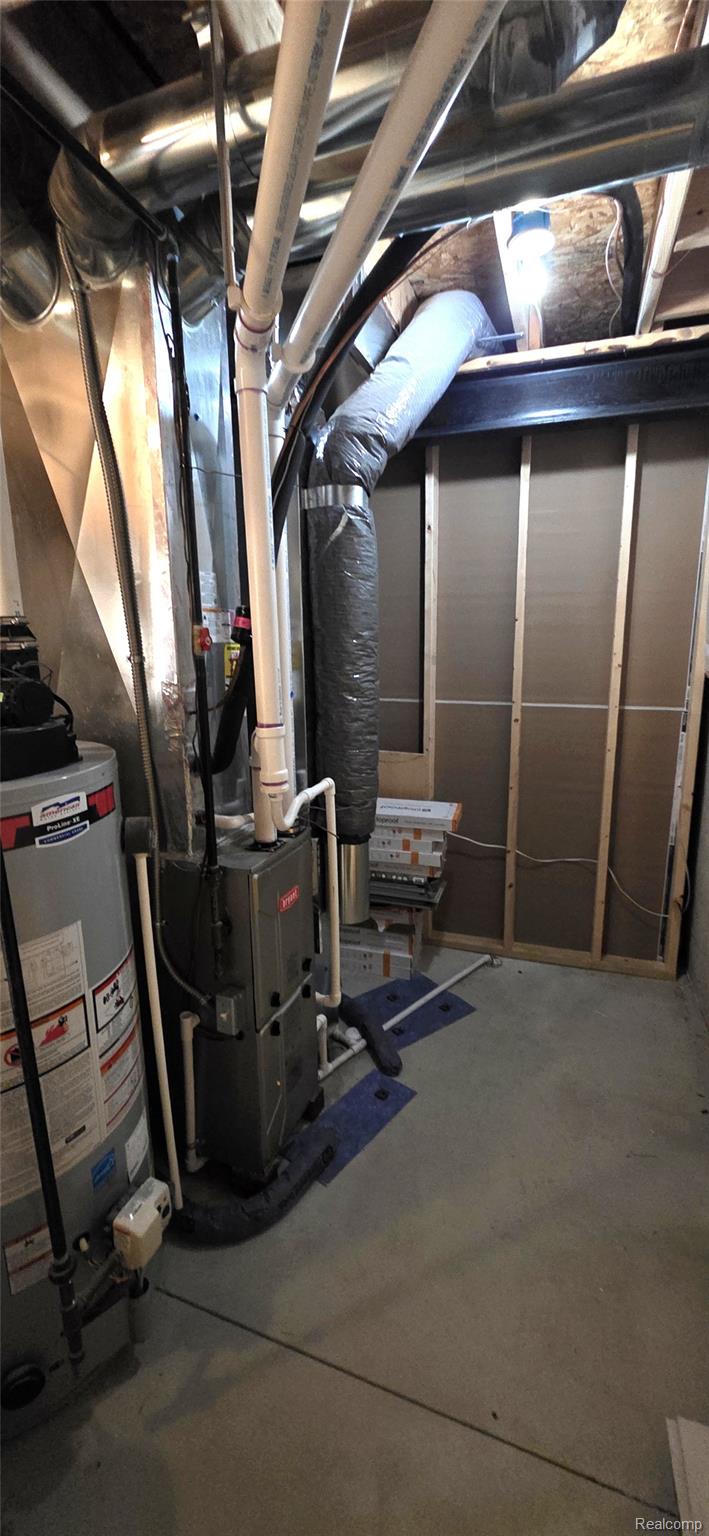 814 Nelson's Ridge Drive Howell, MI 48843 - Photo 38 of 40 Utility room with gas water heater and heating unit