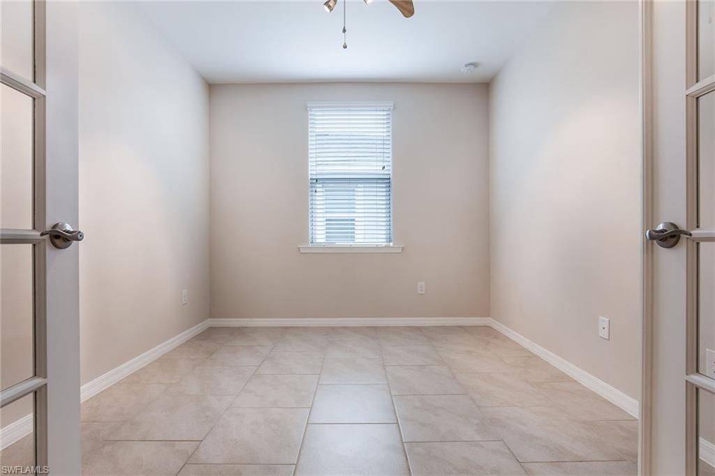 14533 Edgewater Circle Naples, FL 34114 - Photo 9 of 24 a view of an empty room with a window