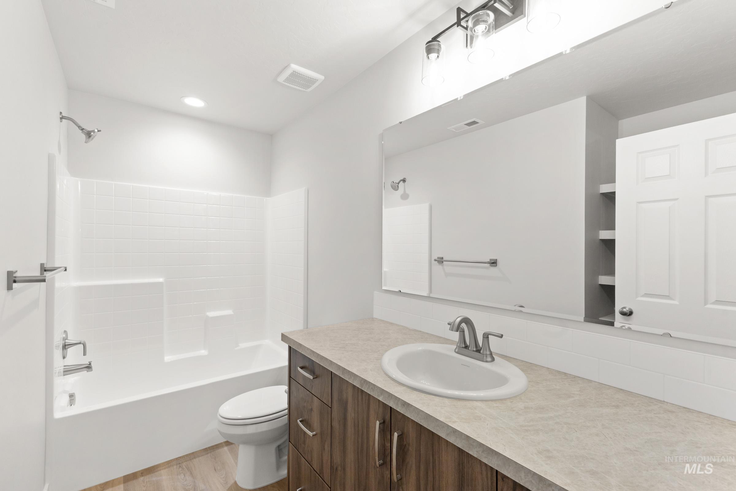 461 Waverly Avenue Middleton, ID 83644 - Photo 15 of 22 Full bath with vanity, bathing tub / shower combination, and light wood-type flooring