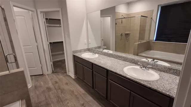 a bathroom with a granite countertop sink shower double and mirror