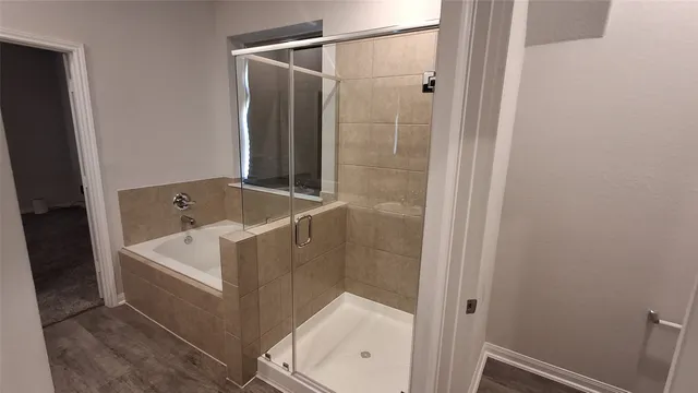 a bathroom with a bathtub and shower