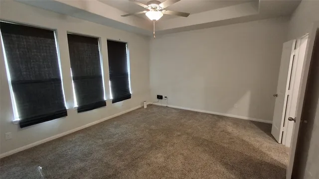 an empty room with fan and entrance