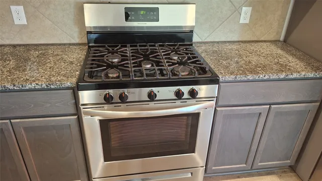 a stove top oven sitting inside of a kitchen