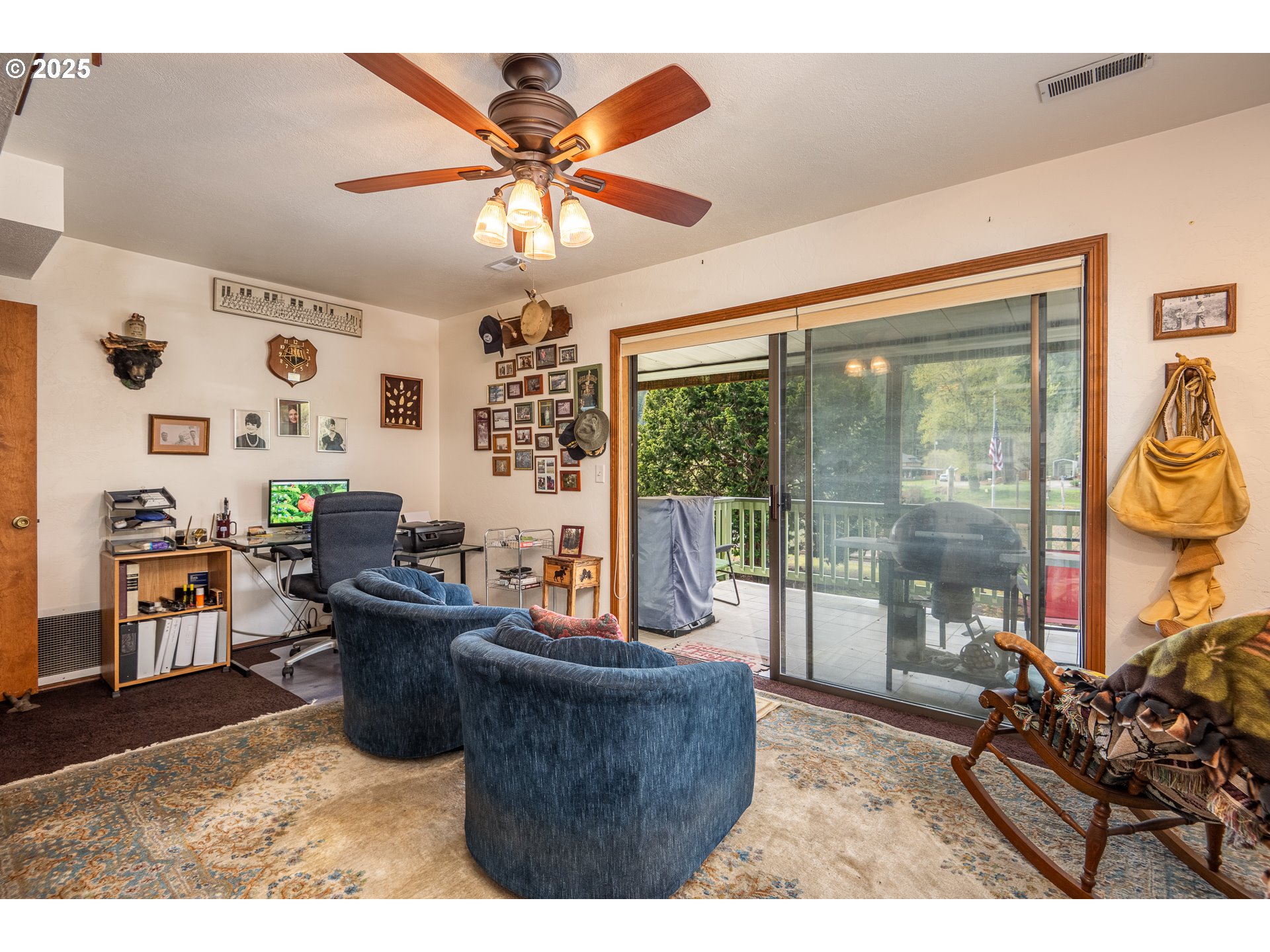 10927 East Mapleton Road Mapleton, OR 97453 - Photo 16 of 47 a living room with couches a flat tv screen and a dining table with garden view