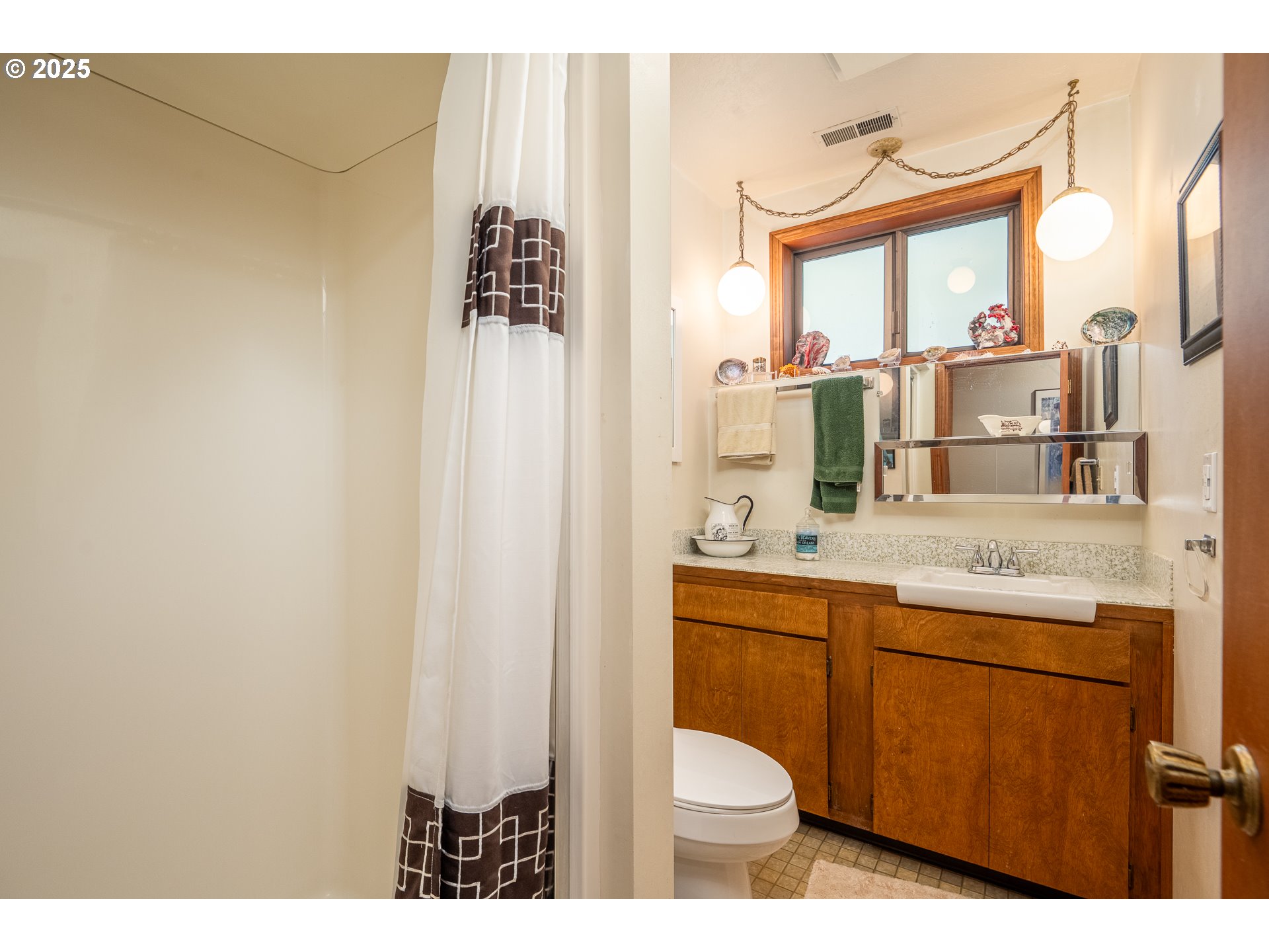 10927 East Mapleton Road Mapleton, OR 97453 - Photo 18 of 47 a bathroom with a granite countertop sink and a mirror