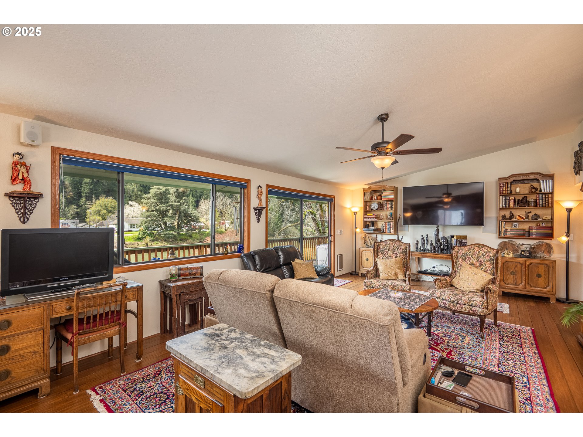 10927 East Mapleton Road Mapleton, OR 97453 - Photo 35 of 47 a living room with furniture and a flat screen tv