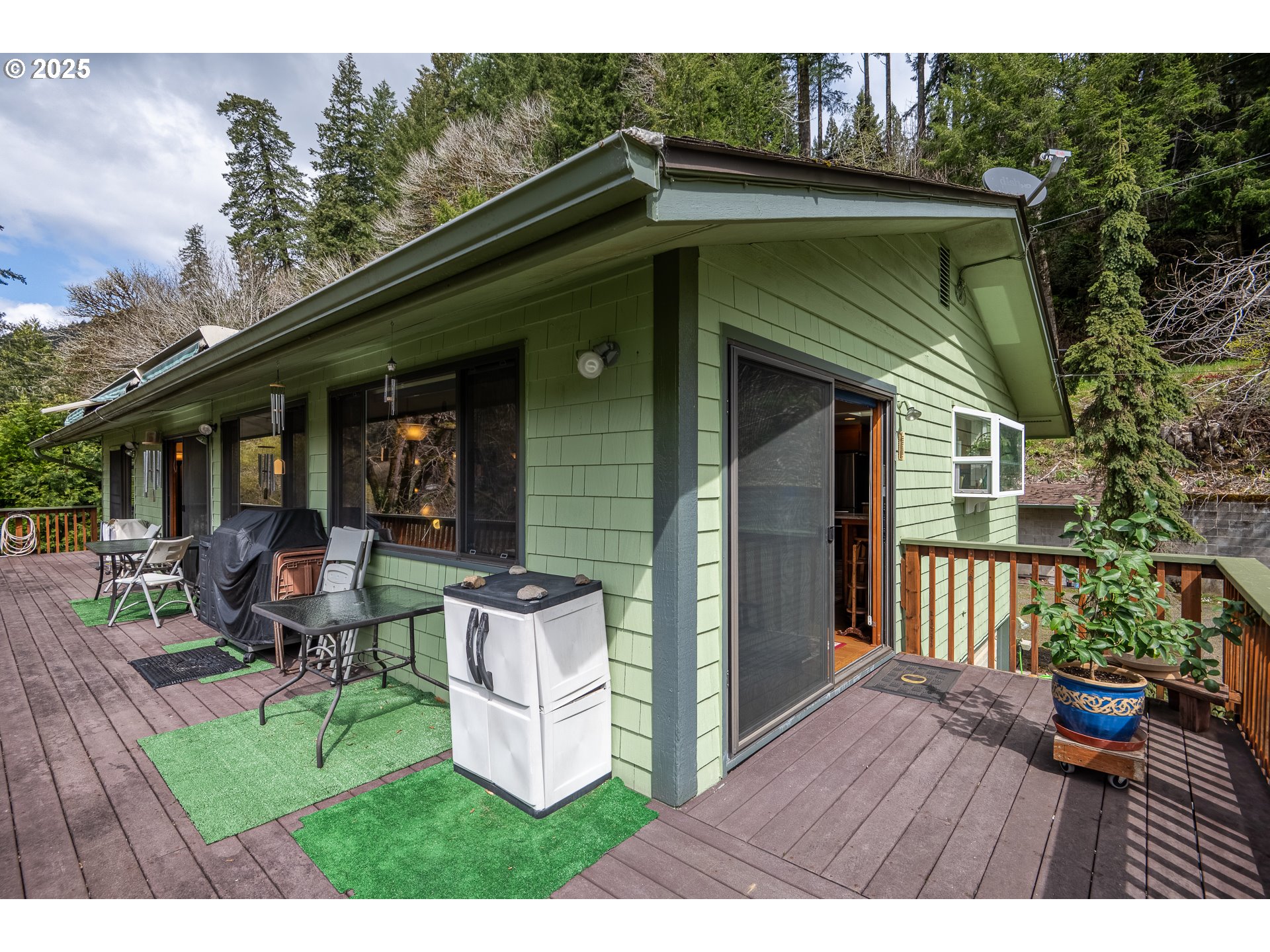 10927 East Mapleton Road Mapleton, OR 97453 - Photo 38 of 47 a view of a house with backyard sitting area and garden