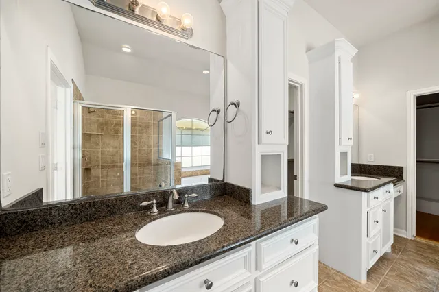 a view of a house with a yard and wooden fence