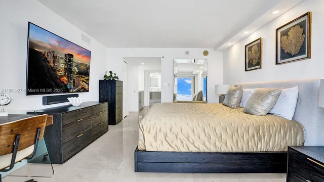 a bed room with a bed and a flat screen tv