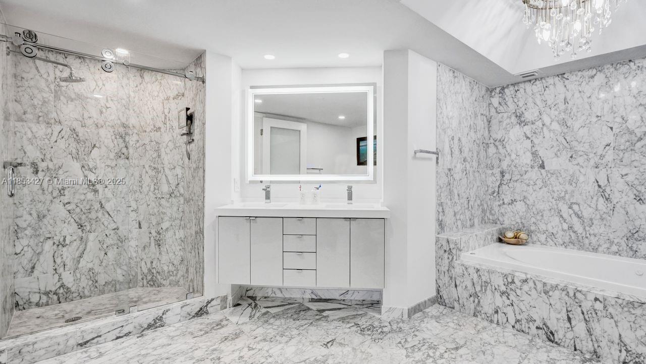 5757 Collins Avenue, Unit 1605 Miami Beach, FL 33140 - Photo 15 of 40 a bathroom with a sink and a mirror