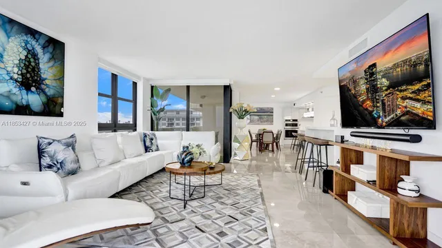 a living room with furniture a flat screen tv and a wall painting