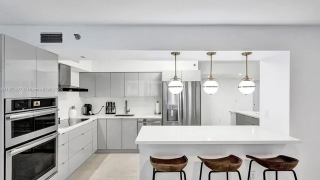 a large kitchen with cabinets and stainless steel appliances