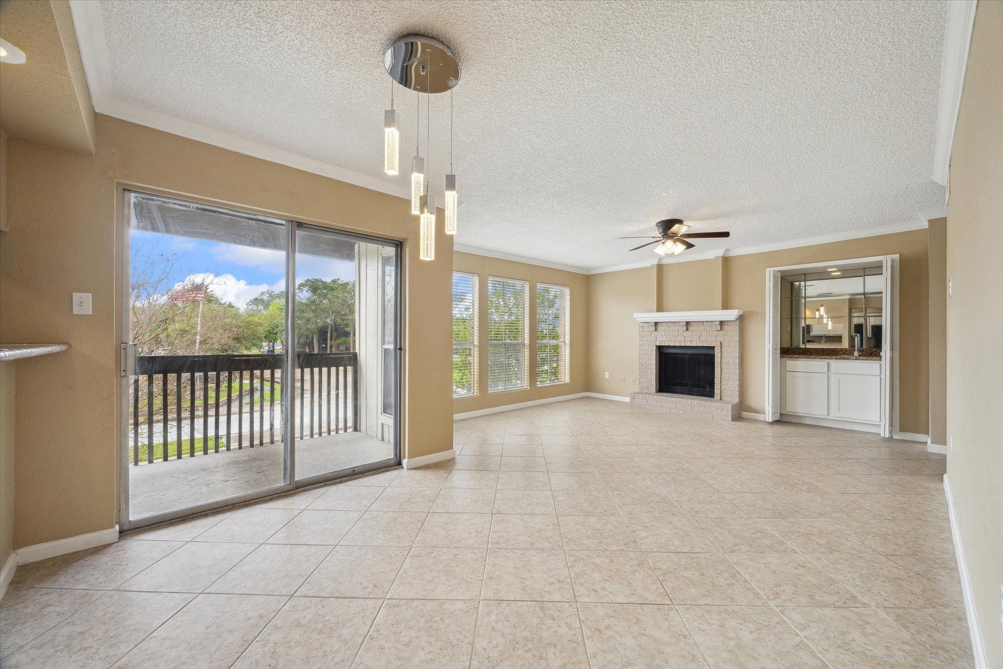 1500 Bay Area Boulevard, Unit 422 Houston, TX 77058 - Photo 5 of 14 a view of empty room with floor to ceiling window and fireplace