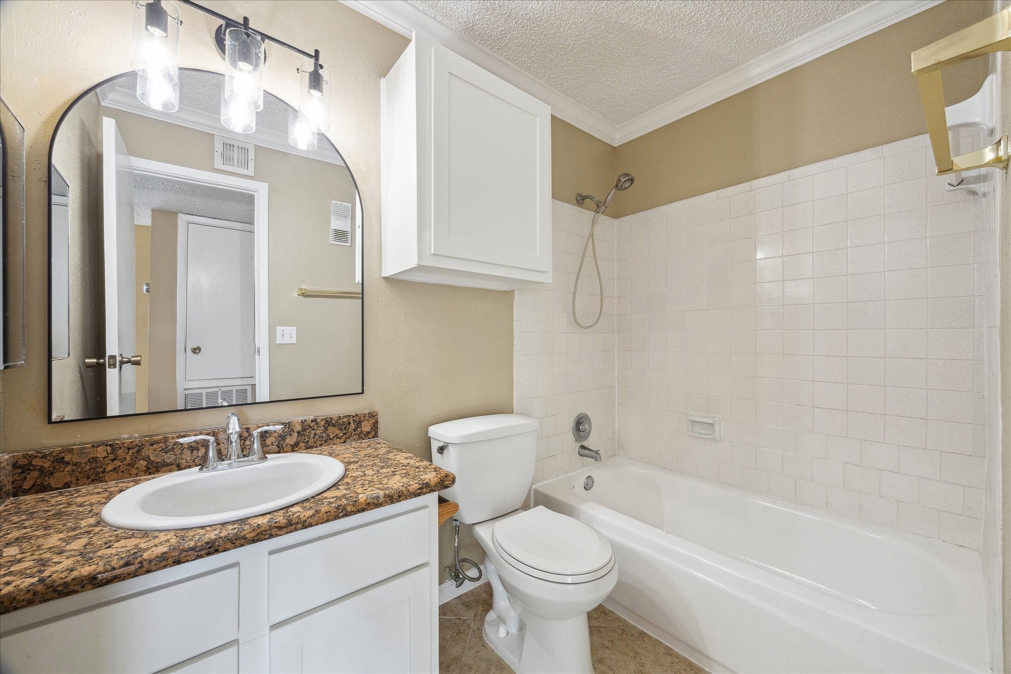 1500 Bay Area Boulevard, Unit 422 Houston, TX 77058 - Photo 9 of 14 a bathroom with a granite countertop sink mirror toilet and bathtub