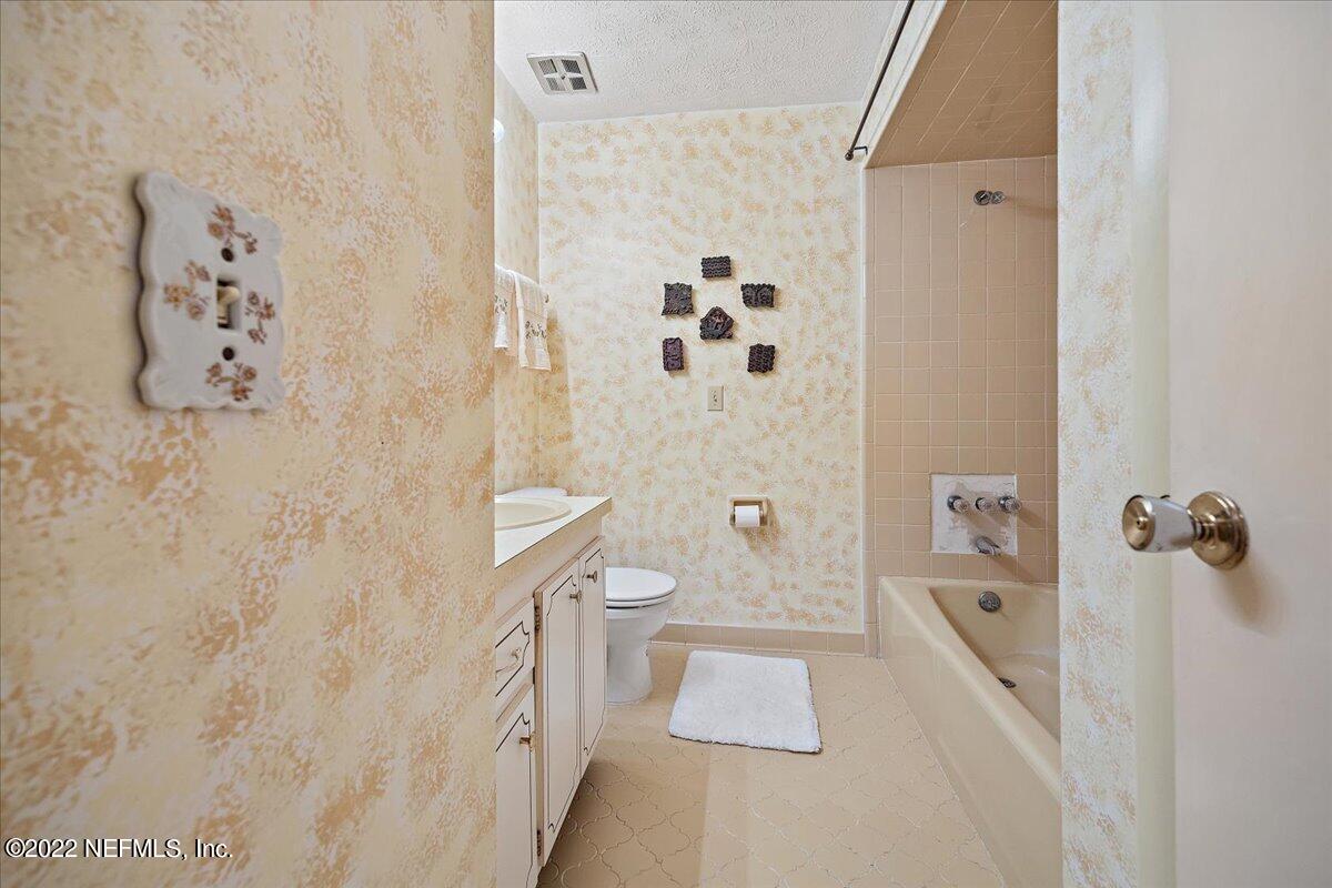 5504 Weaver Road Orange Park, FL 32073 - Photo 12 of 15 a bathroom with a granite countertop sink a toilet and shower