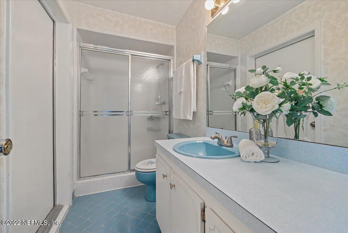 5504 Weaver Road Orange Park, FL 32073 - Photo 10 of 15 a bathroom with a granite countertop sink a toilet and a mirror