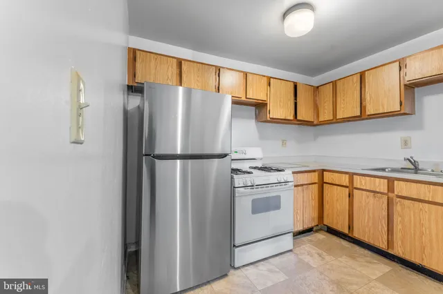 a kitchen with stainless steel appliances granite countertop a refrigerator sink and cabinets