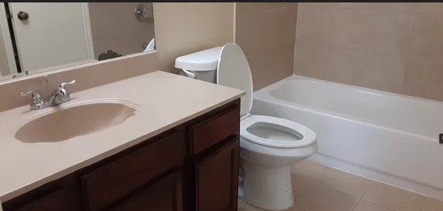 a bathroom with a sink toilet and a bathtub