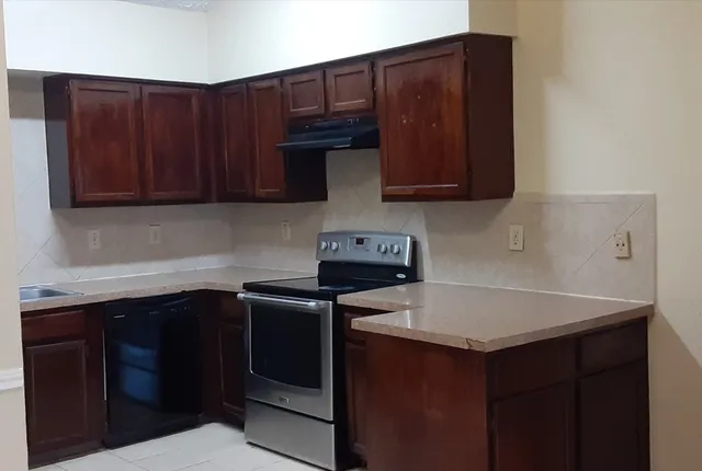 a kitchen with a sink and cabinets