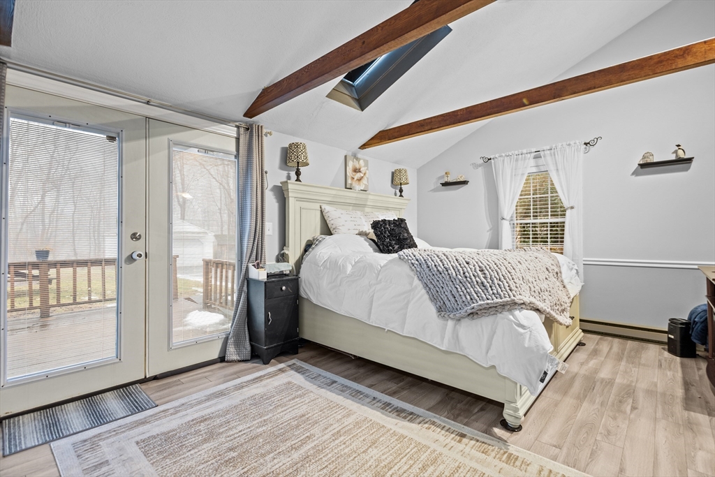 14 Mine Brook Road Rehoboth, MA 02769 - Photo 13 of 40 a bedroom with a large bed and wooden floor