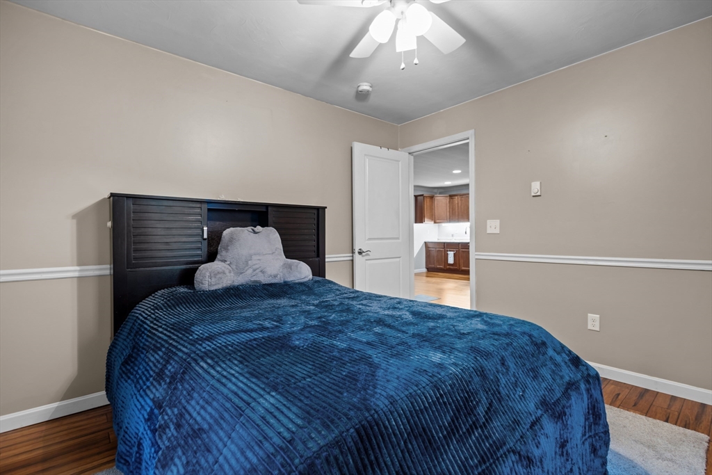 14 Mine Brook Road Rehoboth, MA 02769 - Photo 36 of 40 a spacious bedroom with a bed and a chandelier