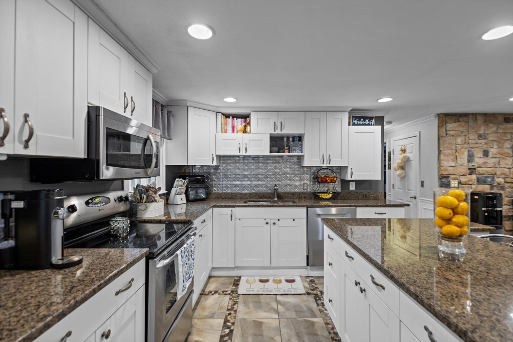 14 Mine Brook Road Rehoboth, MA 02769 - Photo 6 of 40 a kitchen with stainless steel appliances granite countertop a sink stove microwave and refrigerator