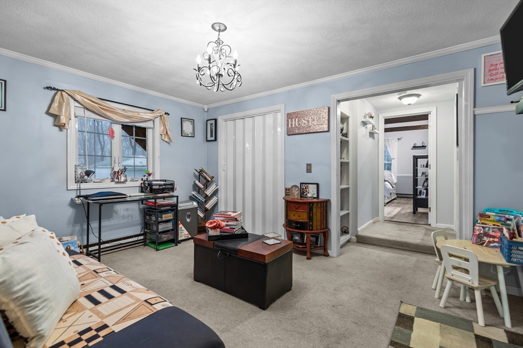 14 Mine Brook Road Rehoboth, MA 02769 - Photo 8 of 40 a bed room with furniture and a chandelier