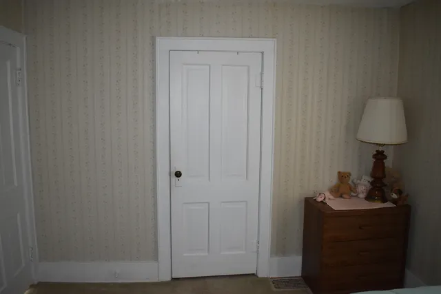 a room that has a dresser in it and a mirror