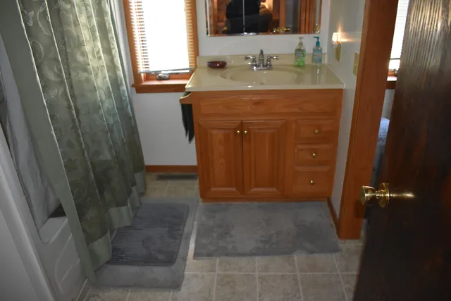 a bathroom with a sink a vanity and a mirror