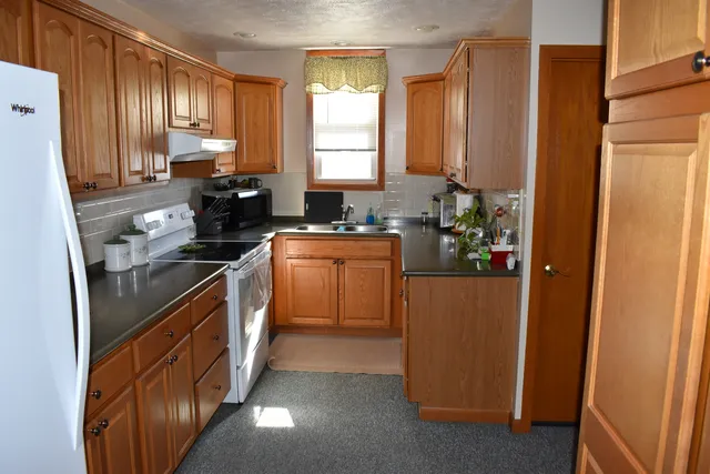 a kitchen with a sink stove and refrigerator