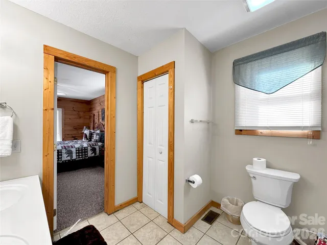 a bathroom with a toilet a sink and glass door