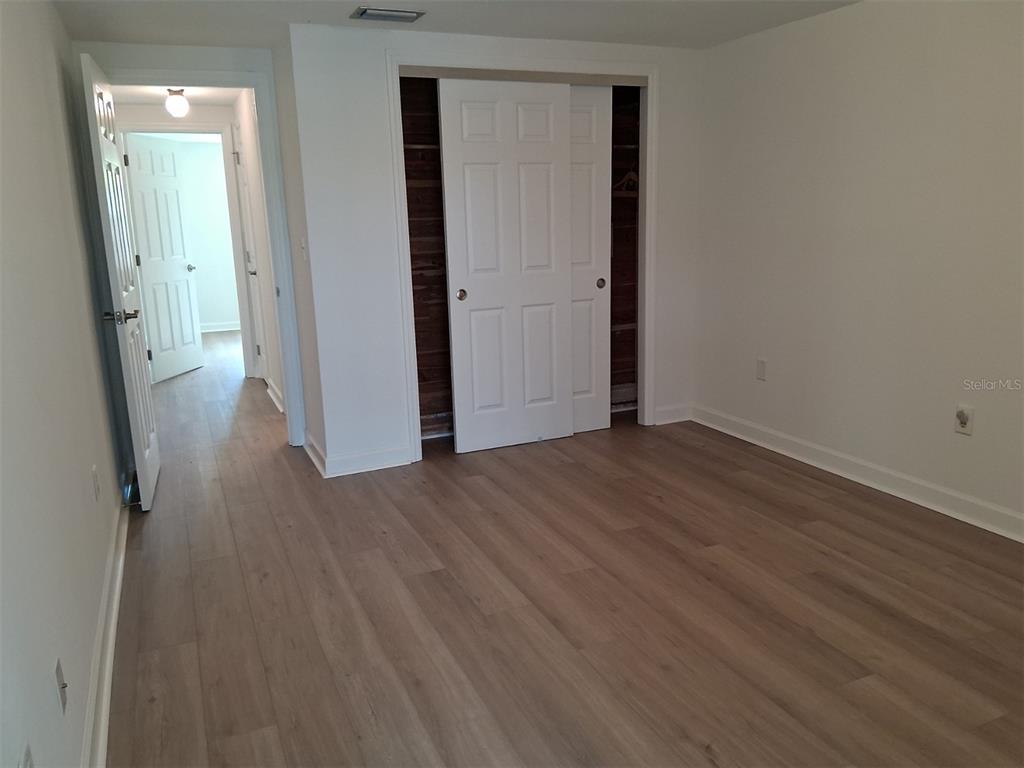 4326 Summersun Drive New Port Richey, FL 34652 - Photo 13 of 28 an empty room with wooden floor and a window