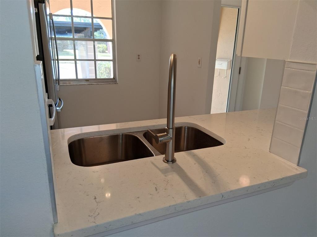 4326 Summersun Drive New Port Richey, FL 34652 - Photo 4 of 28 a view of a sink a faucet a fire pit and a window