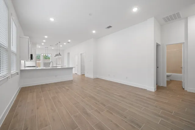 a view of kitchen and hall with wooden floor