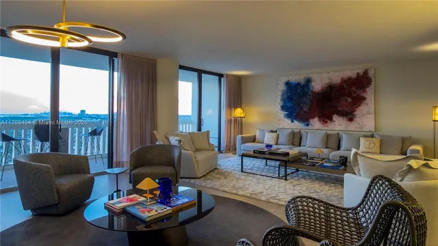 a living room with furniture and a floor to ceiling window