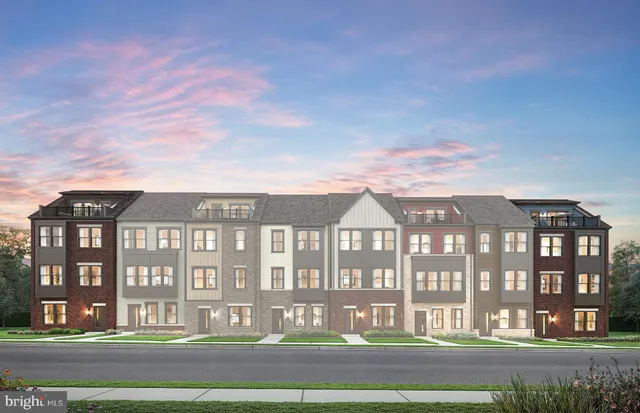 a front view of a residential apartment building with a yard