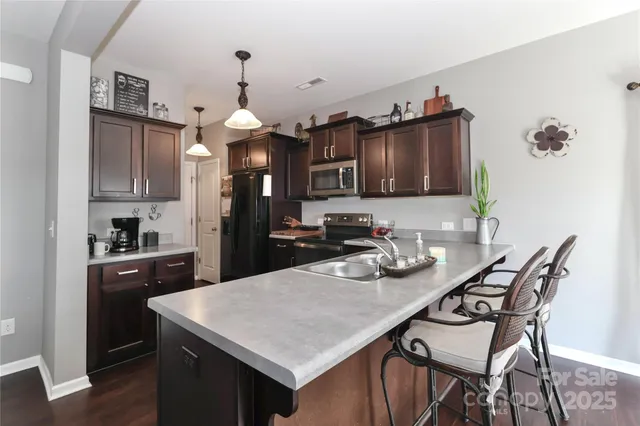 a kitchen with sink cabinets and appliances