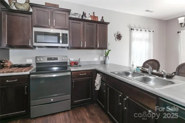 a kitchen with a sink a counter space and dining table