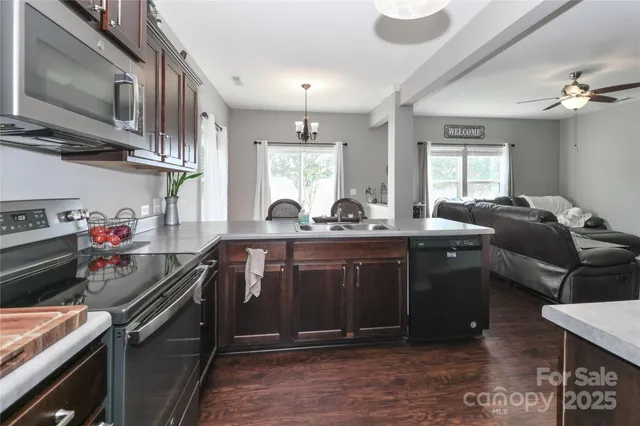 a view of a livingroom with wooden floor and a large window