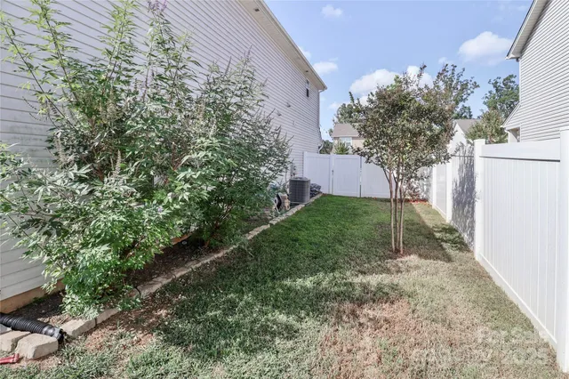 a view of a backyard with a table and chair and potted plants