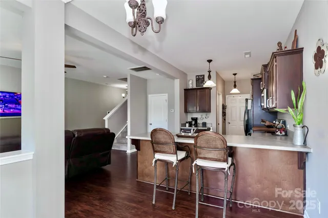 a dining room with furniture and wooden floor
