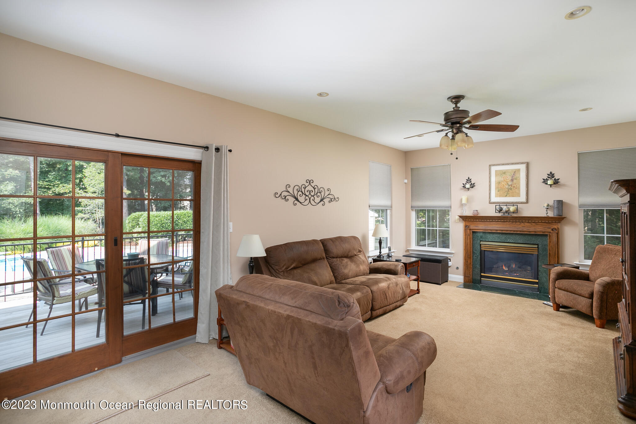 68 Erin Drive Jackson, NJ 08527 - Photo 14 of 40 a living room with furniture a fireplace and a flat screen tv
