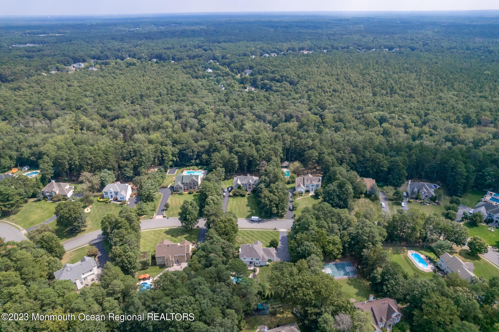 68 Erin Drive Jackson, NJ 08527 - Photo 40 of 40 an aerial view of a houses with a lush green hillside