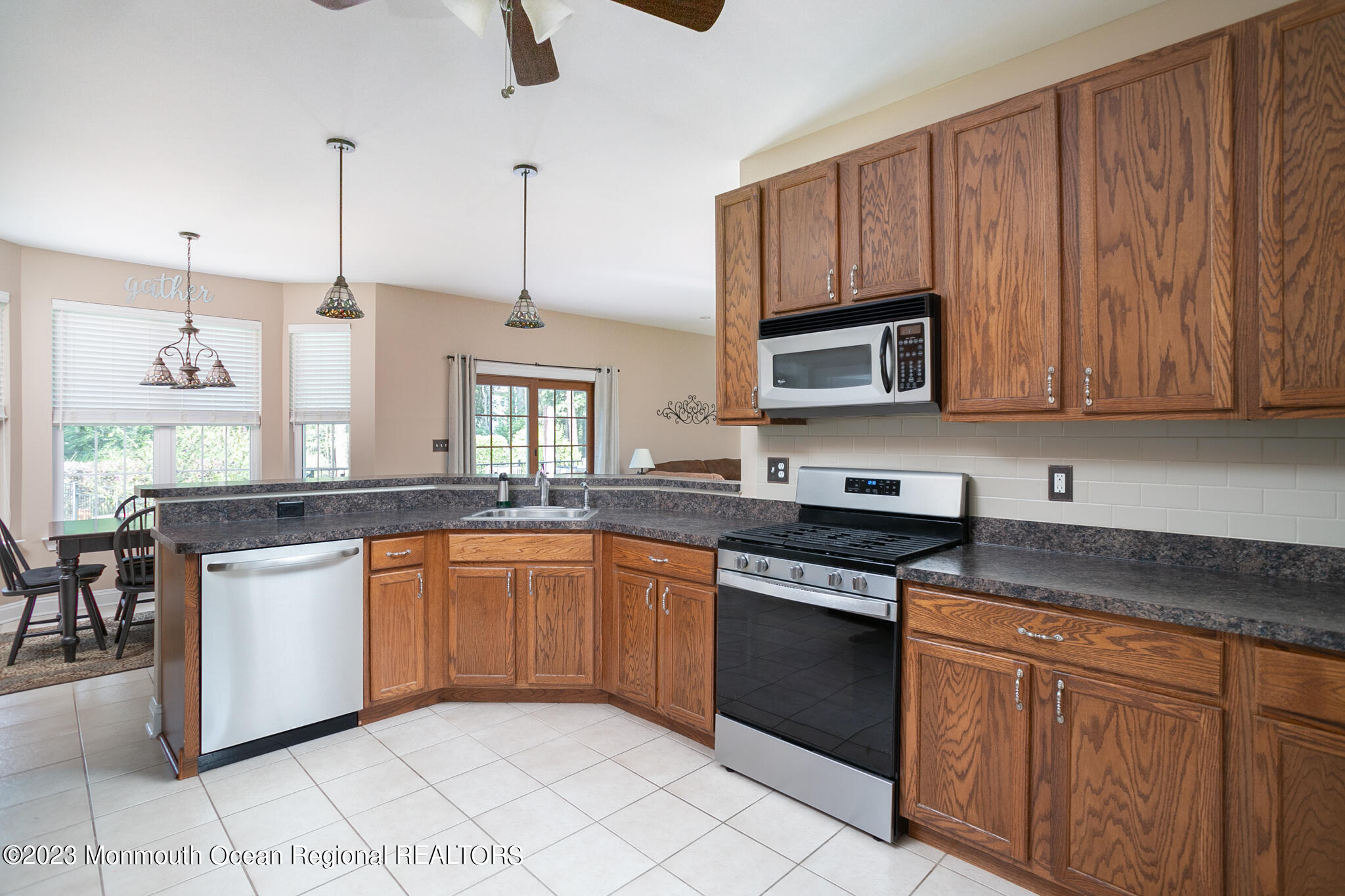 68 Erin Drive Jackson, NJ 08527 - Photo 8 of 40 a kitchen with stainless steel appliances granite countertop a stove a sink dishwasher and a microwave oven with white cabinets