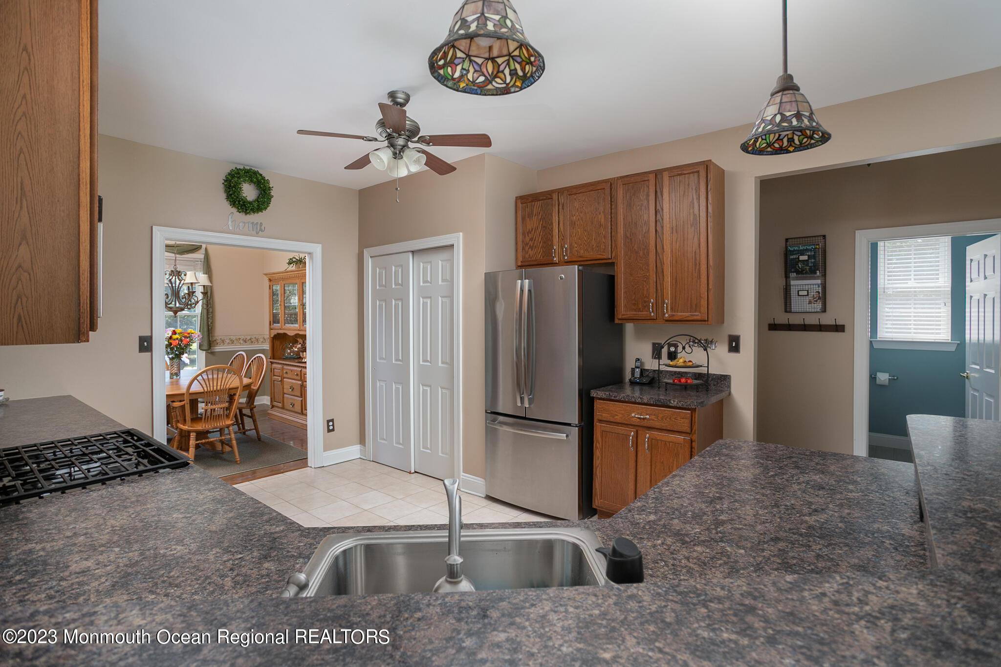 68 Erin Drive Jackson, NJ 08527 - Photo 9 of 40 a kitchen with stainless steel appliances granite countertop a refrigerator a stove a sink a dining table and chairs with wooden floor
