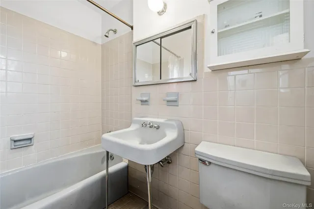 a bathroom with a sink a toilet and bathtub